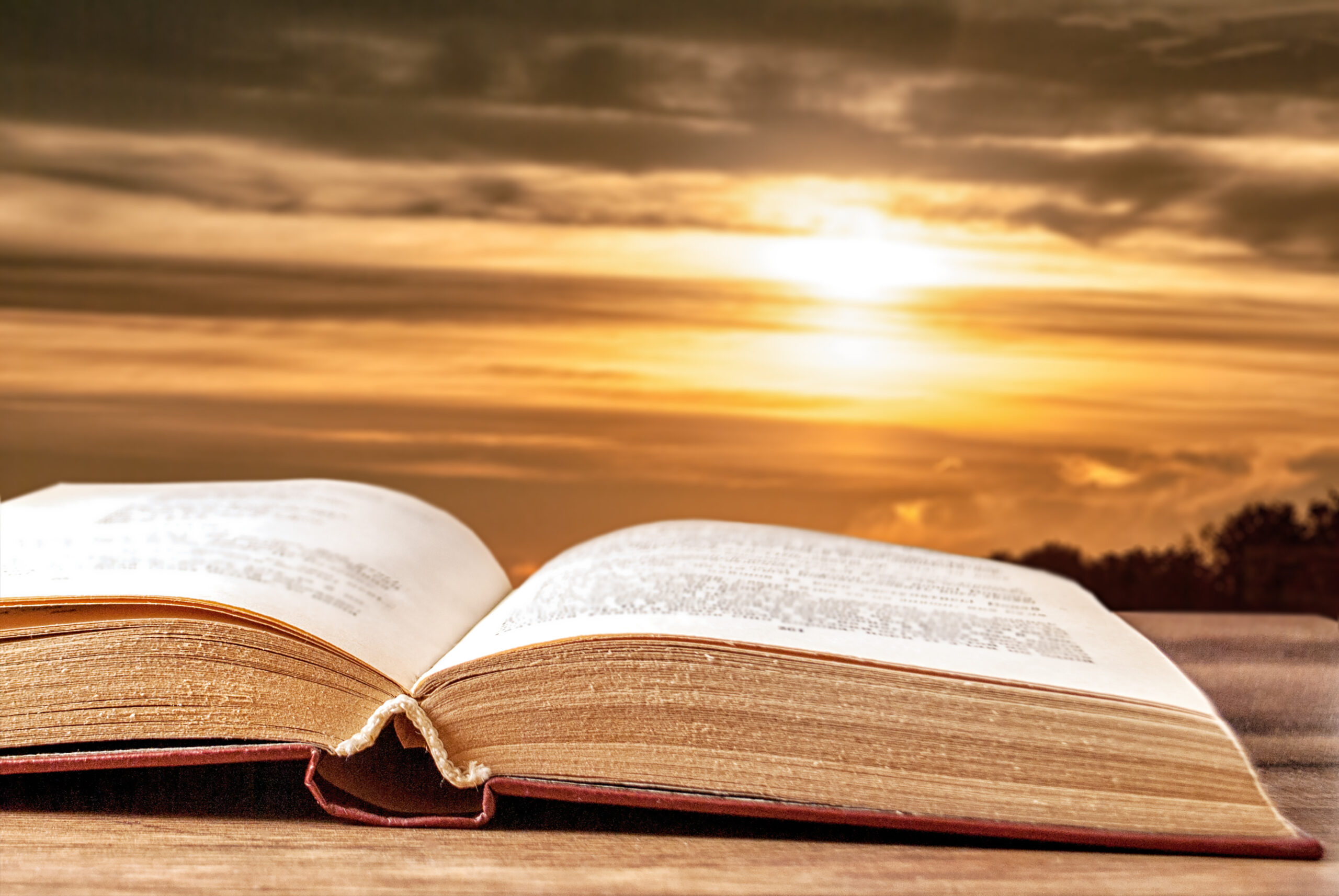 Open book against a beautiful sunset
